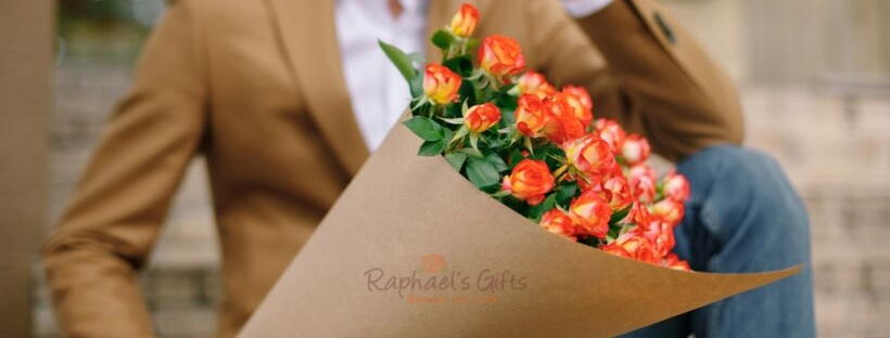 A man holding a bouquet of orange flowers